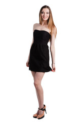 Fototapeta premium Attractive young woman in a black dress smiling and looking at c