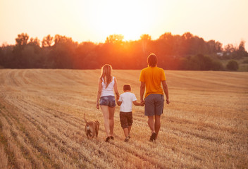 Fototapeta na wymiar happy family with dog walking