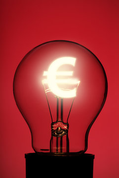 Light bulb with glowing Euro symbol on red
