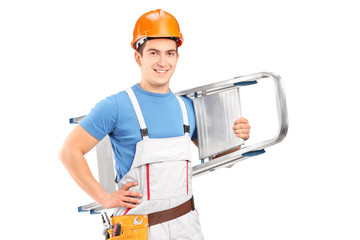 A manual worker with a helmet carrying a ladder