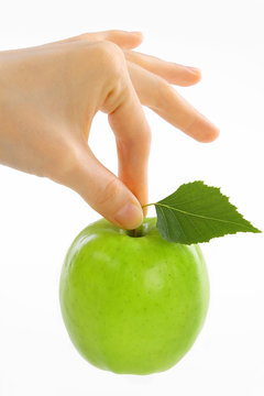 woman, female hand take green apple with leaf