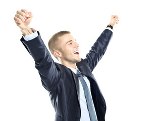 Excited handsome business man with arms raised in success
