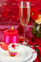 Table setting in honor of Valentine's Day on red background