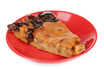 Tasty pie on red plate isolated on white
