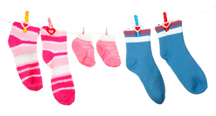 Colorful socks hanging on clothesline, isolated on white