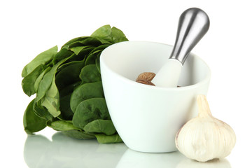 Mortar, herbs and garlic, isolated on white