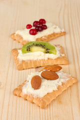 Tasty canapes with cheese, kiwi and cranberry, almond,