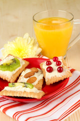 Tasty canapes with cheese, kiwi and cranberry, almond,