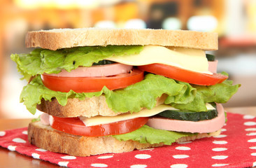 Tasty sandwich on table in cafe