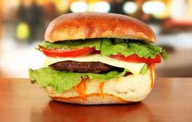 Big and tasty hamburger on table in cafe