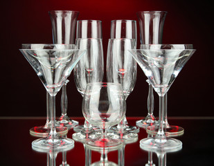 Cocktail and wine glasses, on dark red background
