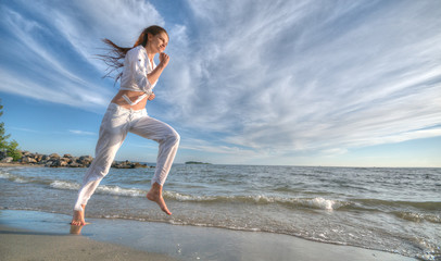 Sporty woman running in sea coast
