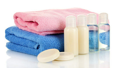 Obraz na płótnie Canvas Hotel cosmetic bottles with towel isolated on white