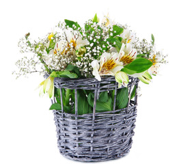 Bouquet of flowers in basket isolated on white