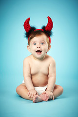 little funny baby with devil horns