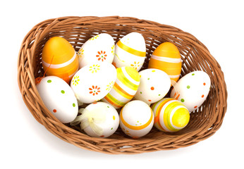 Easter eggs in basket isolated on white background