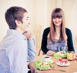 Young caucasian couple dining in restaurant