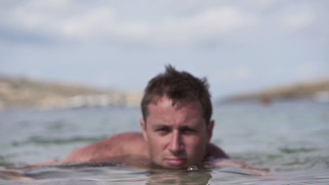 Happy man relaxing in sea, super slow motion, shot at 240fps