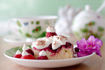 Closeup on sweet cake with cup of tea on wooden table