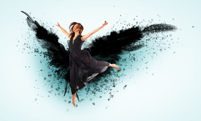 Woman floating   on dark wings