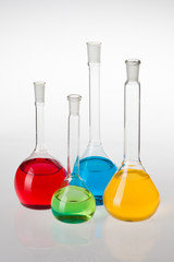 Laboratory glassware with liquids of different colors