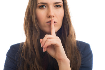 Naklejka premium woman holds a finger near the mouth