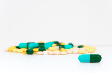 Pills capsules with many  lying on ground