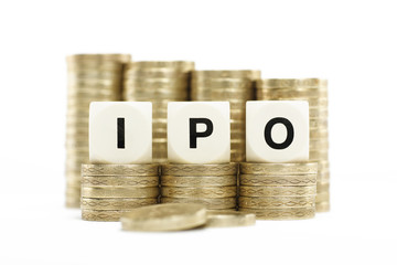 IPO (Initial Public Offering) on gold coins on white background