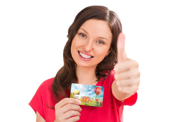 Extremely positive woman holding bank plastic credit or debit ca