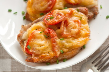 Pork with onion, cherry tomatoes  and cheese