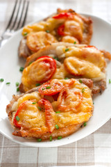 Pork with onion, cherry tomatoes  and cheese