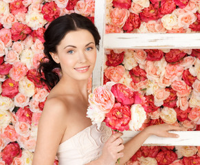 woman with old ladder and background full of roses