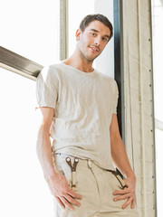 handsome man standing on the windowsill