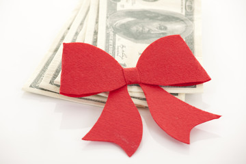 Money, gift wrapped in red bow and ribbon, one hundred dollars b