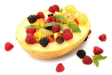 fresh fruits salad in melon  and berries, isolated on white