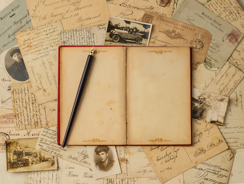 Vintage background with old post cards and empty open book
