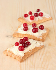 Cookie with cheese and cranberry, on wooden background