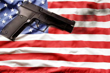 Gun control in the USA. Handgun on American flag