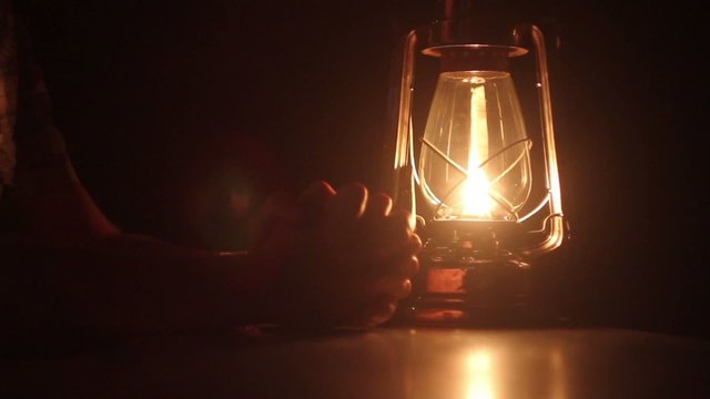 lamp and hands in the dark