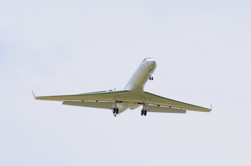 Landing airplane on cloudy sky