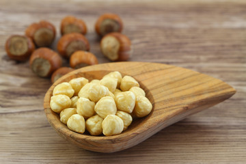 Hazelnuts in miniature wooden bowl, close up