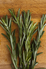 branch of rosemary on a wooden board