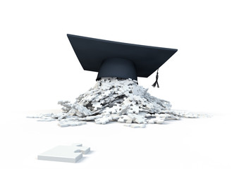 graduation cap (mortar board) on a pile of puzzle pieces