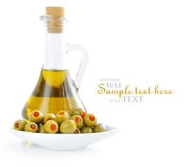 Green olives stuffed with pimento with bottle of olive oil