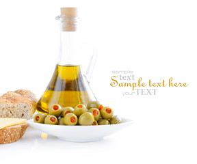 Green olives, oil, slices of bread are on a white background