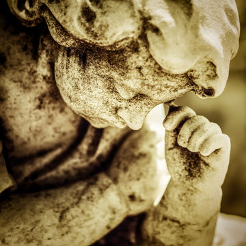 Grunge marble statue of a sad angel