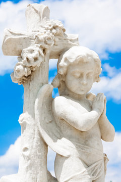 Infant angel with a blue sky background