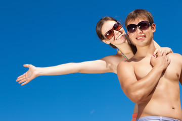 Happy Young Couple Together On The Beach