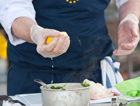 Chef Adding Lemon Juice In Food