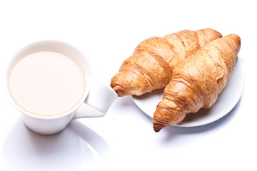 Coffee cup with a croissant isolated on white 